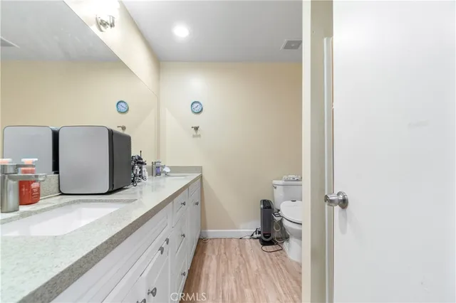 a bathroom with a granite countertop sink and a mirror