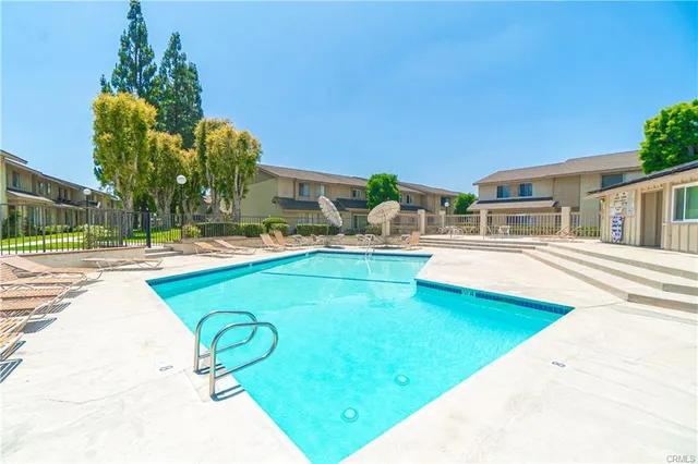 a swimming pool with outdoor seating and yard