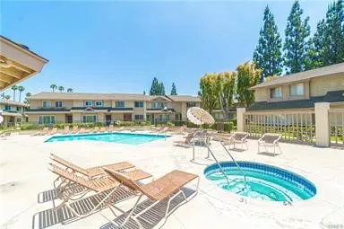 a swimming pool with outdoor seating and yard