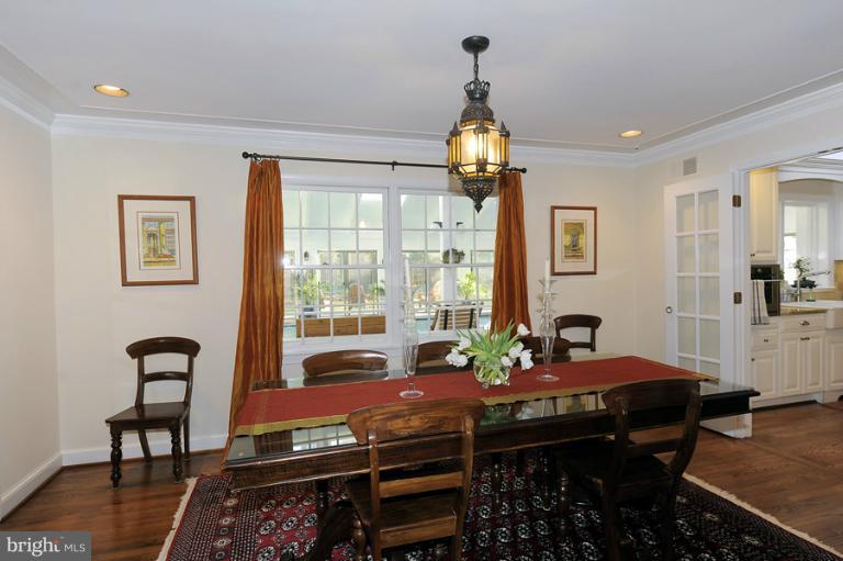 7720 Greentree Road Bethesda, MD 20817 - Photo 11 of 23 a bedroom with a bed and a chandelier