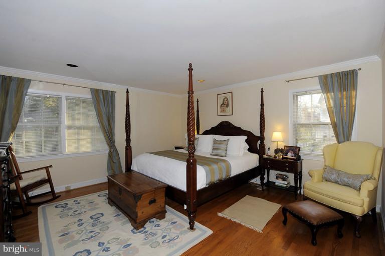 7720 Greentree Road Bethesda, MD 20817 - Photo 12 of 23 a bedroom with a bed a table and chair