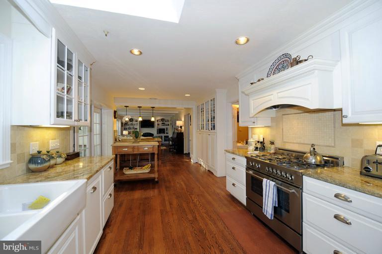 7720 Greentree Road Bethesda, MD 20817 - Photo 15 of 23 a kitchen with stainless steel appliances granite countertop a stove and cabinets