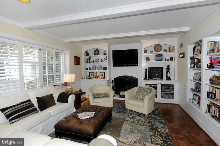 7720 Greentree Road Bethesda, MD 20817 - Photo 20 of 23 a living room with furniture a flat screen tv and a fireplace