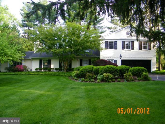 7720 Greentree Road Bethesda, MD 20817 - Photo 23 of 23 a front view of a house with a garden