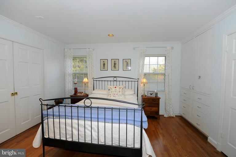 7720 Greentree Road Bethesda, MD 20817 - Photo 4 of 23 a bedroom with a bed and wooden floor