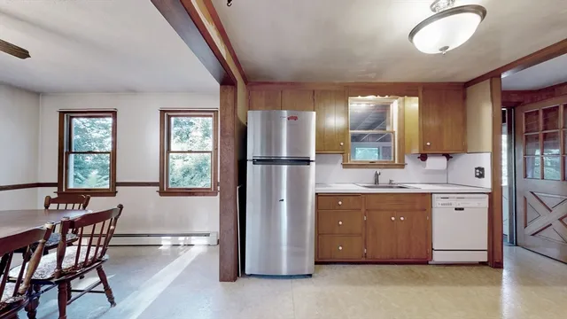 a kitchen with stainless steel appliances granite countertop a sink and a refrigerator
