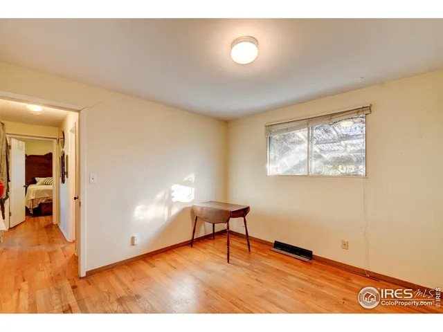 a view of an empty room and wooden floor