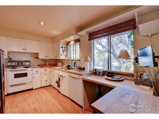 a kitchen with a stove a sink and a refrigerator
