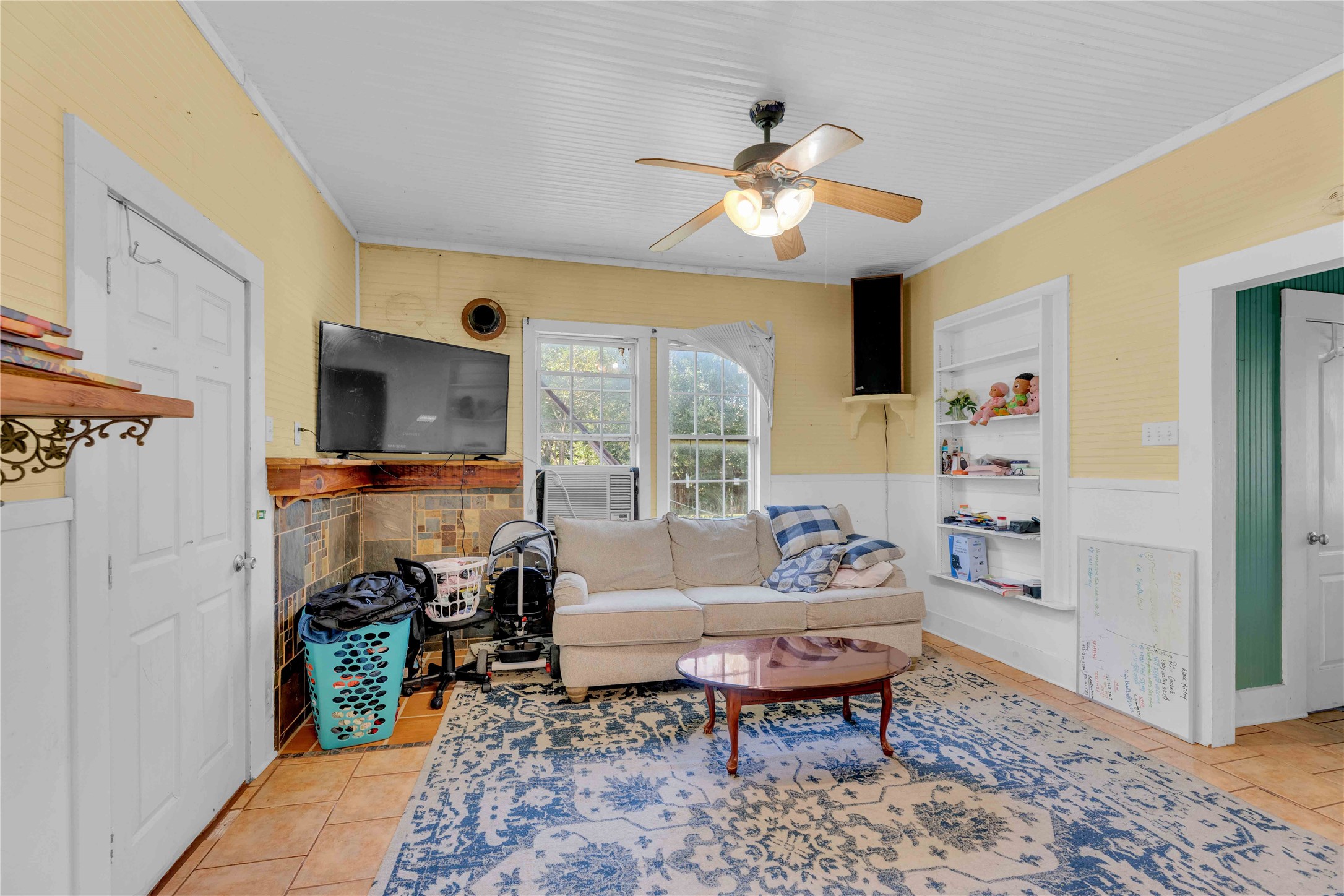 20235 Engelmann Lane Manor, TX 78653 - Photo 21 of 34 Living area with crown molding, light tile patterned flooring, and a ceiling fan