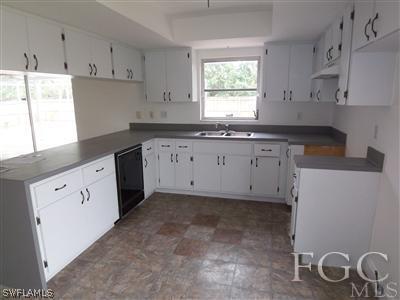 8376 Matanzas Road Fort Myers, FL 33967 - Photo 2 of 10 a kitchen with granite countertop white cabinets white appliances and a granite counter tops
