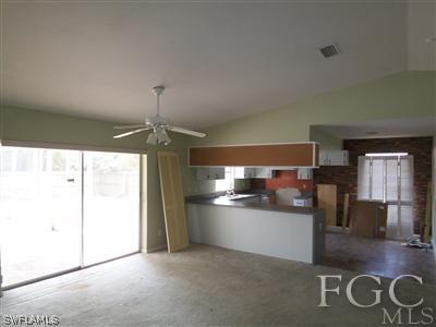 8376 Matanzas Road Fort Myers, FL 33967 - Photo 3 of 10 a kitchen with stainless steel appliances granite countertop a refrigerator and a stove top oven