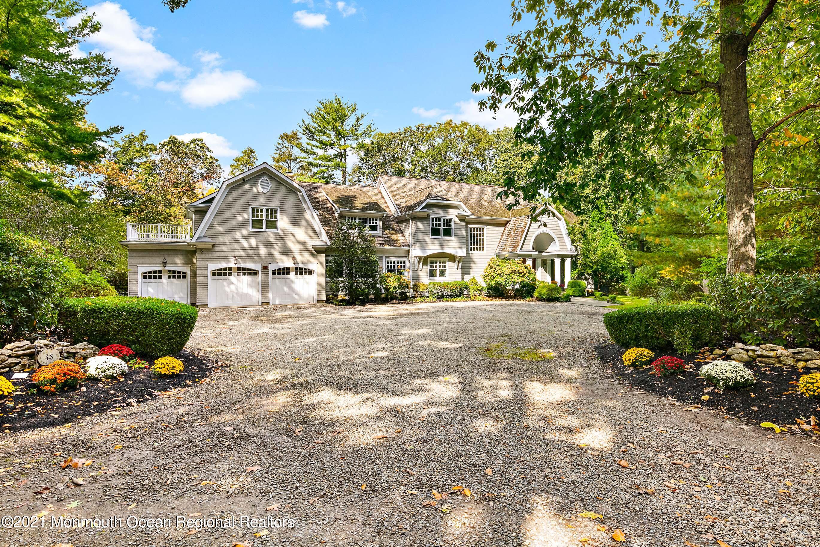 43 Muhlenbrink Road Colts Neck, NJ 07722 - Photo 2 of 89 a front view of a house with a yard and garage