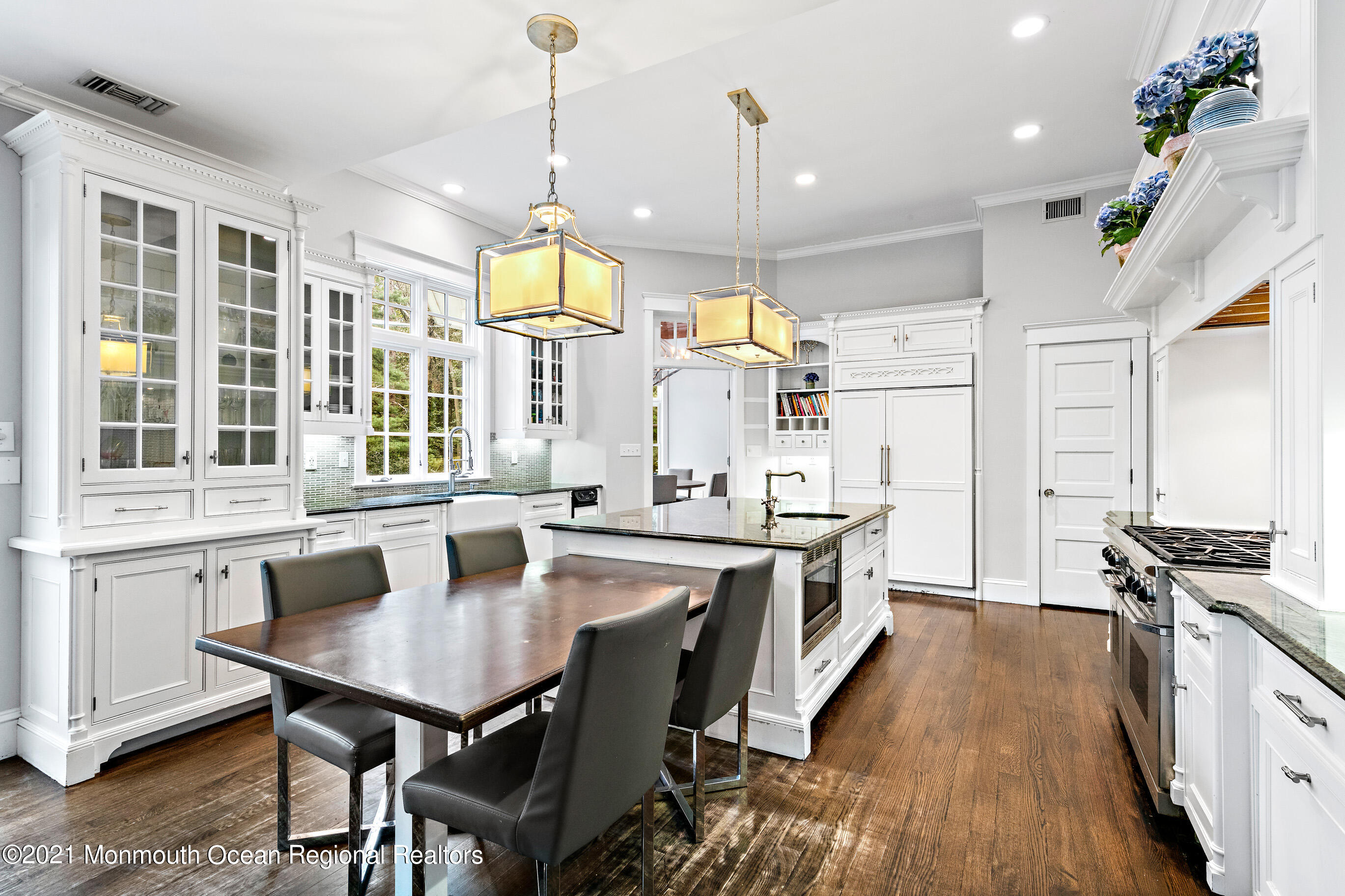 43 Muhlenbrink Road Colts Neck, NJ 07722 - Photo 21 of 89 a kitchen with stainless steel appliances granite countertop a stove a sink dishwasher a dining table and chairs with wooden floor