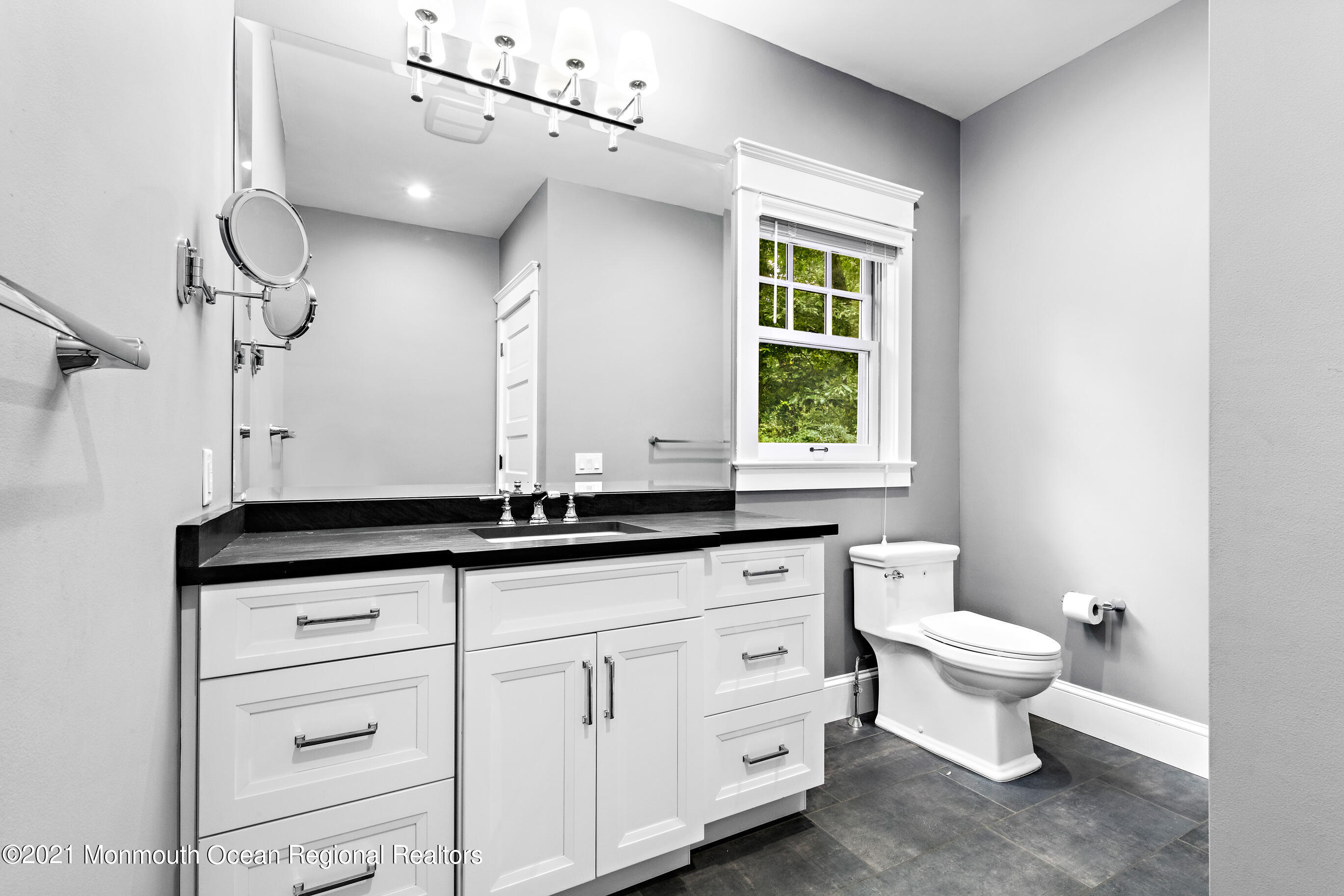 43 Muhlenbrink Road Colts Neck, NJ 07722 - Photo 44 of 89 a bathroom with a granite countertop toilet a sink and a window