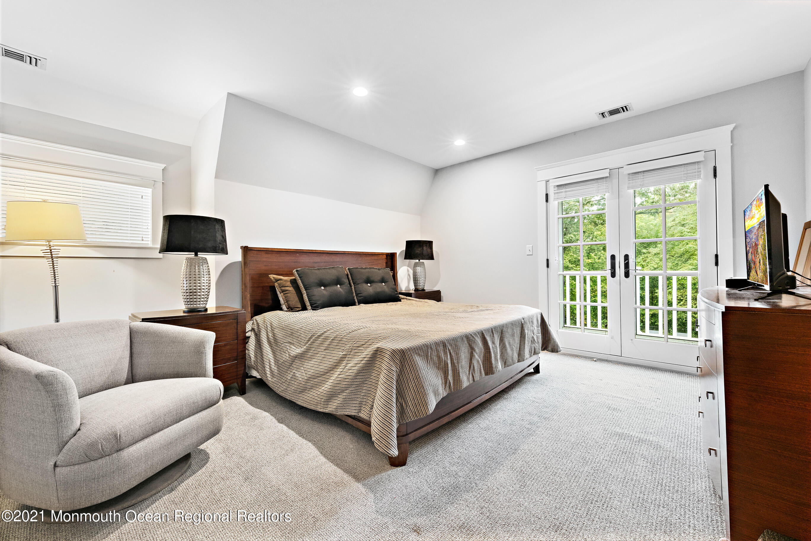 43 Muhlenbrink Road Colts Neck, NJ 07722 - Photo 66 of 89 a spacious bedroom with a bed and a flat screen television