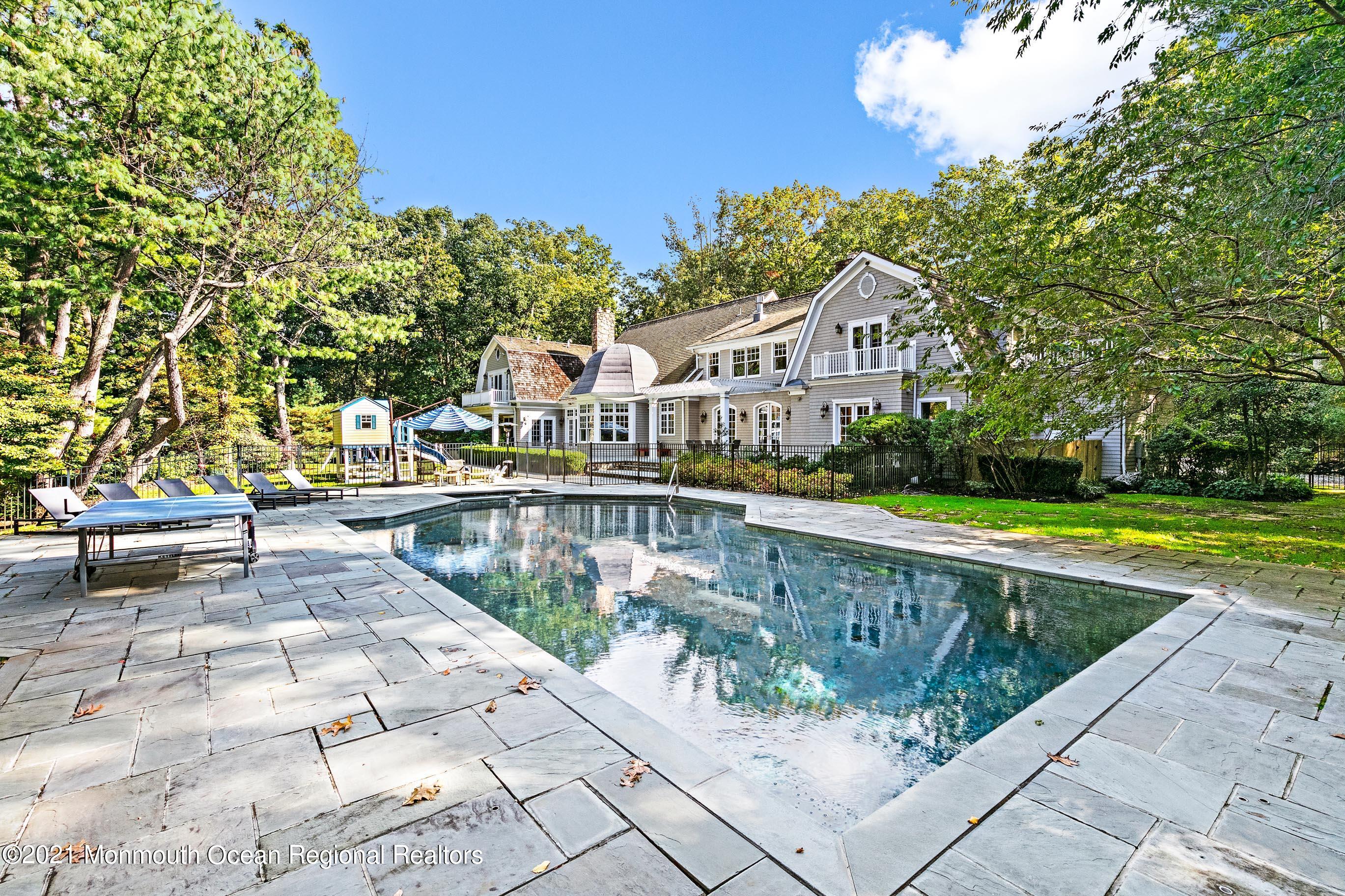 43 Muhlenbrink Road Colts Neck, NJ 07722 - Photo 69 of 89 a view of swimming pool with lawn chairs and plants