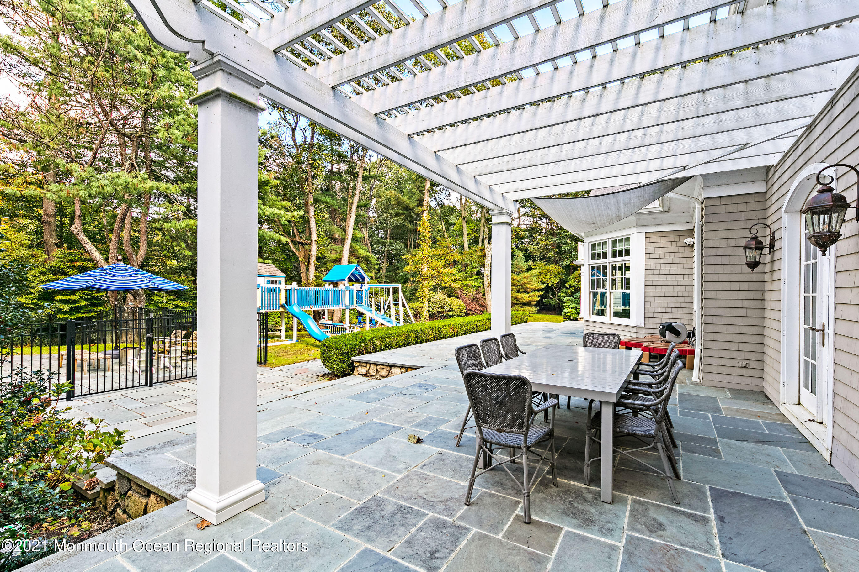 43 Muhlenbrink Road Colts Neck, NJ 07722 - Photo 75 of 89 a view of a patio with a table and chairs and potted plants