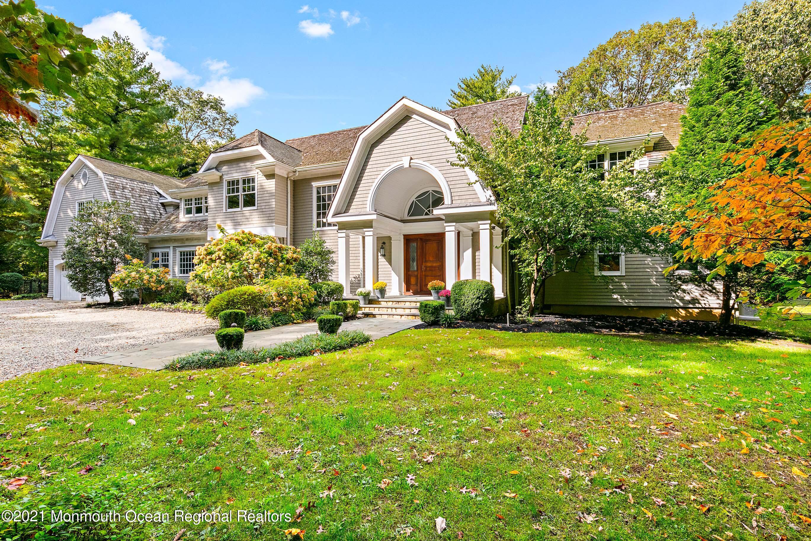 43 Muhlenbrink Road Colts Neck, NJ 07722 - Photo 88 of 89 a front view of a house with a yard and garage