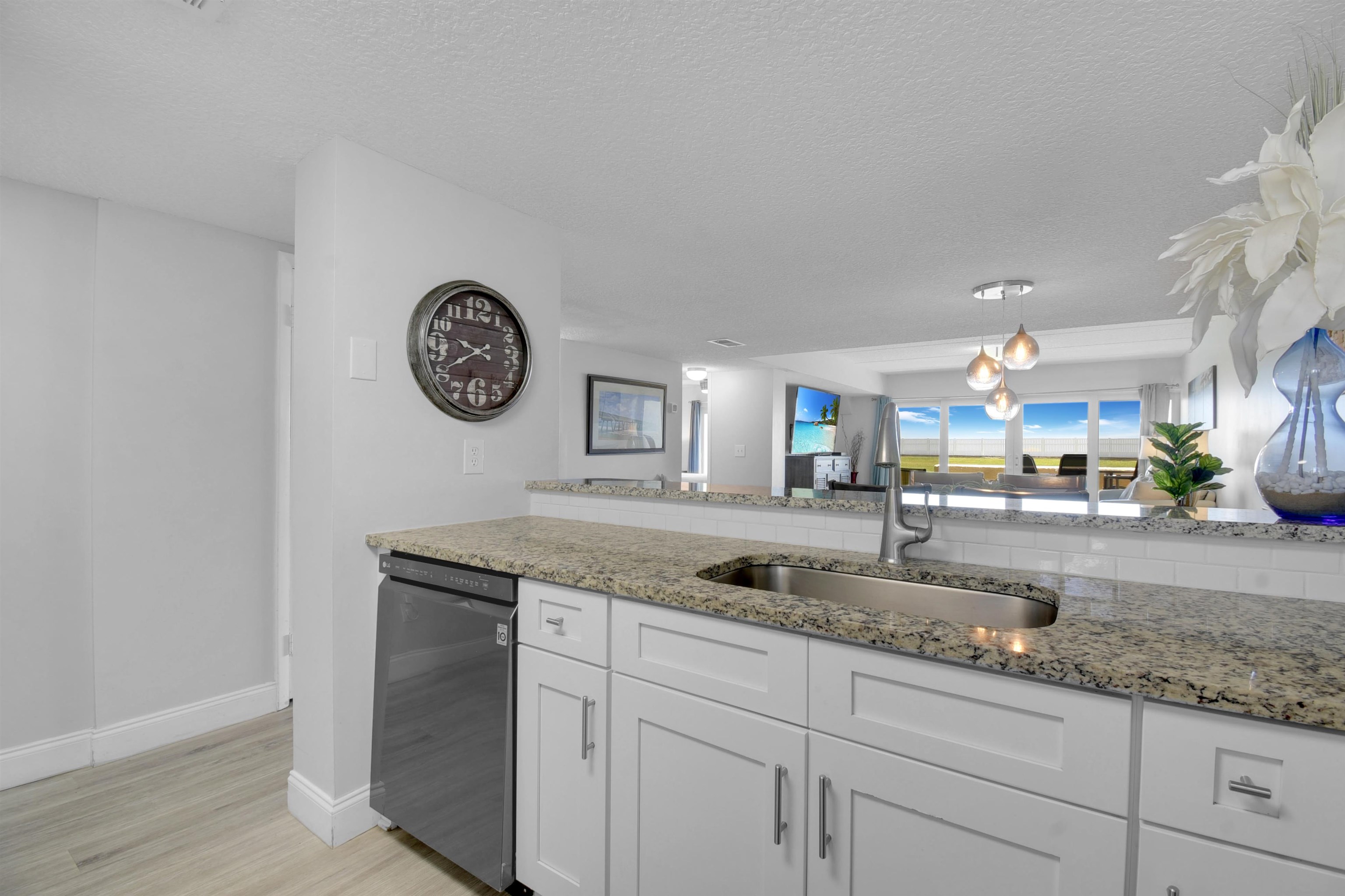 390 A1A Beach Boulevard, Unit 4 St. Augustine Beach, FL 32080 - Photo 15 of 34 a kitchen with granite countertop a sink a stove and cabinets