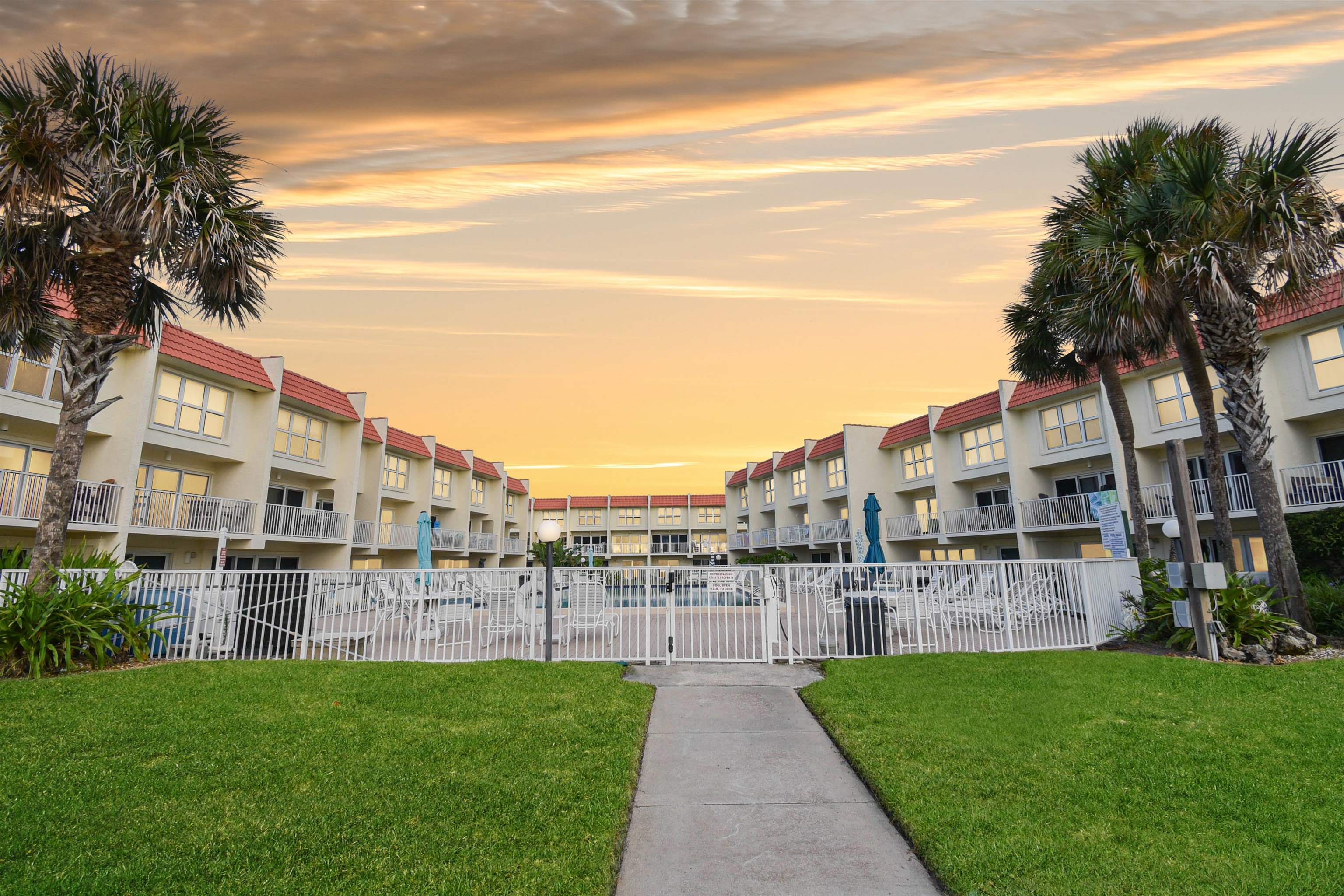 390 A1A Beach Boulevard, Unit 4 St. Augustine Beach, FL 32080 - Photo 25 of 34 a view of a garden with a building in the background