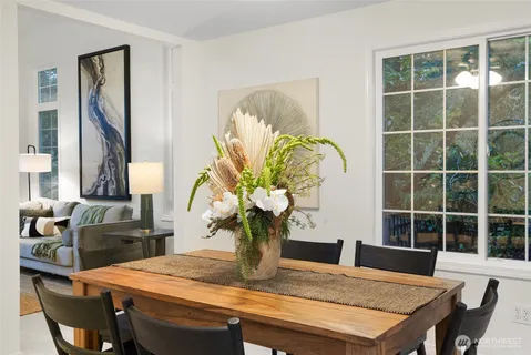a dining room with furniture and wooden floor