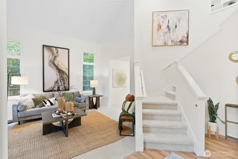 a living room with furniture and large windows
