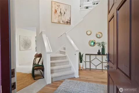 a view of entryway and hall with wooden floor