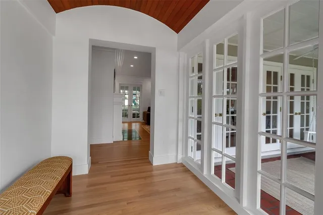 a view of a hallway with wooden floor and staircase
