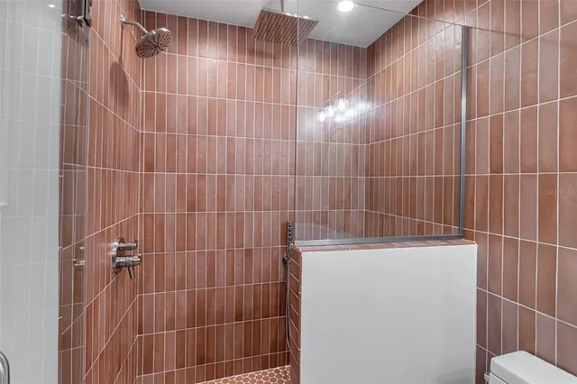 a bedroom with a bed and painting on the wall