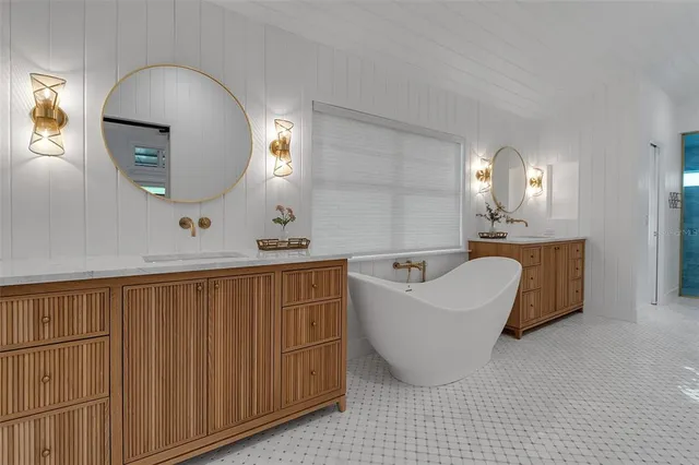 a bathroom with a sink a chair and a potted plant