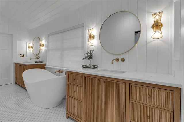 a bedroom with a bed and a large window with wooden floor