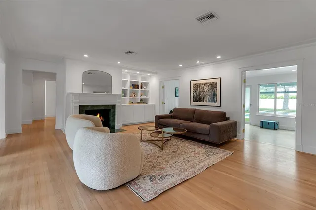 a living room with furniture and a floor to ceiling window