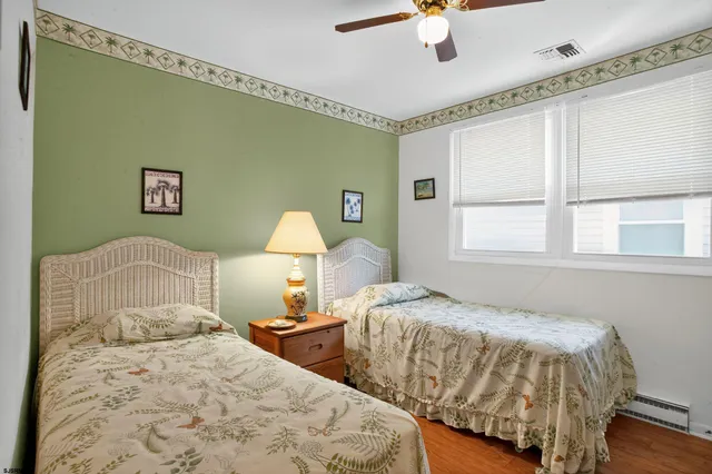 a bedroom with two beds and a chandelier
