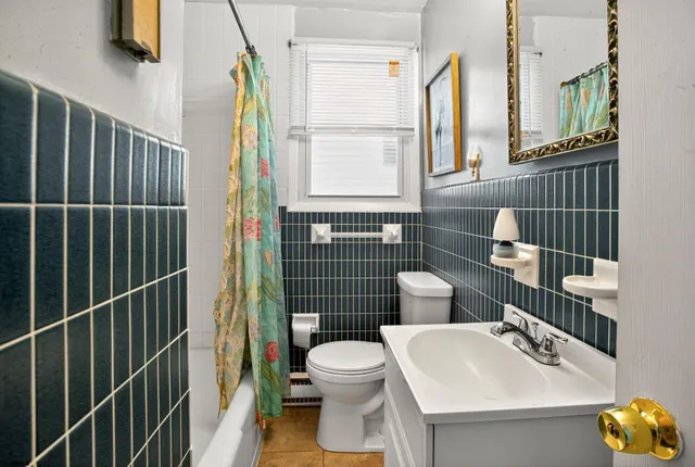 a bathroom with a toilet sink and mirror