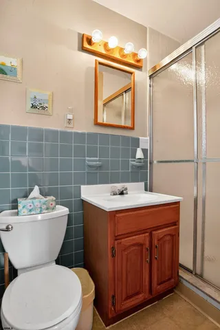 a bathroom with a toilet sink and mirror