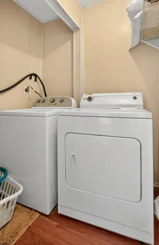 a bathroom with a sink and wooden floor