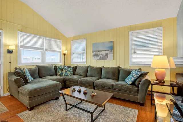 a living room with furniture and a lamp
