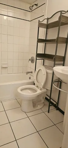 a bathroom with a toilet sink and shower