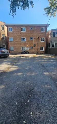 a couple of cars parked in front of a building