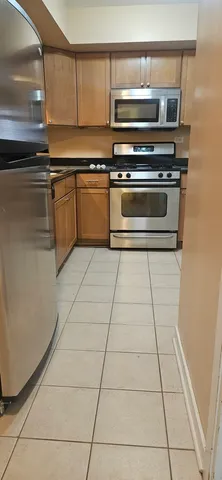 a kitchen with granite countertop a stove a sink and a microwave