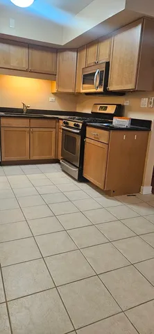 a kitchen with stainless steel appliances granite countertop a sink and a stove