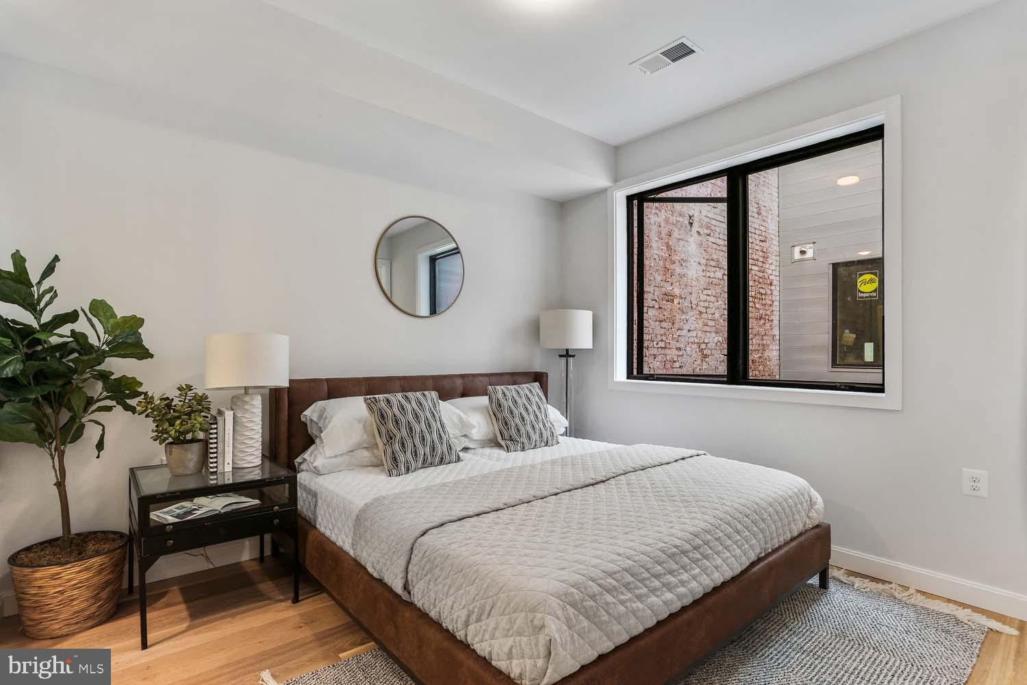 2248 Ontario Road Northwest, Unit 5 Washington, DC 20009 - Photo 21 of 30 a bedroom with a bed and a potted plant