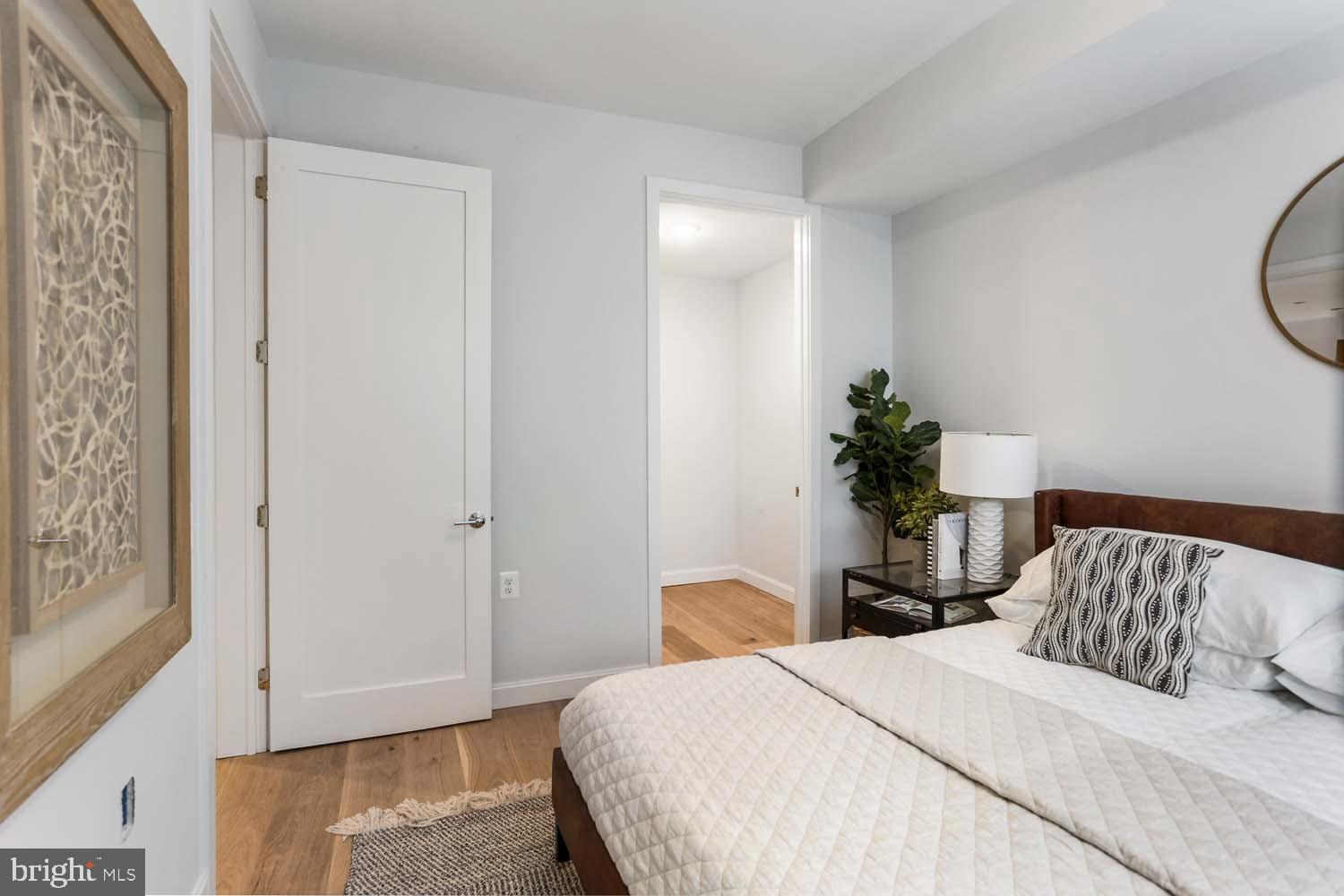 2248 Ontario Road Northwest, Unit 5 Washington, DC 20009 - Photo 22 of 30 a bedroom with a bed and a potted plant