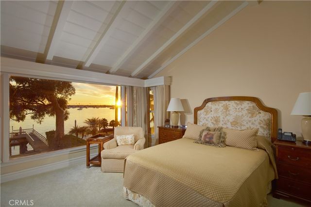 a spacious bedroom with a bed and large glass window