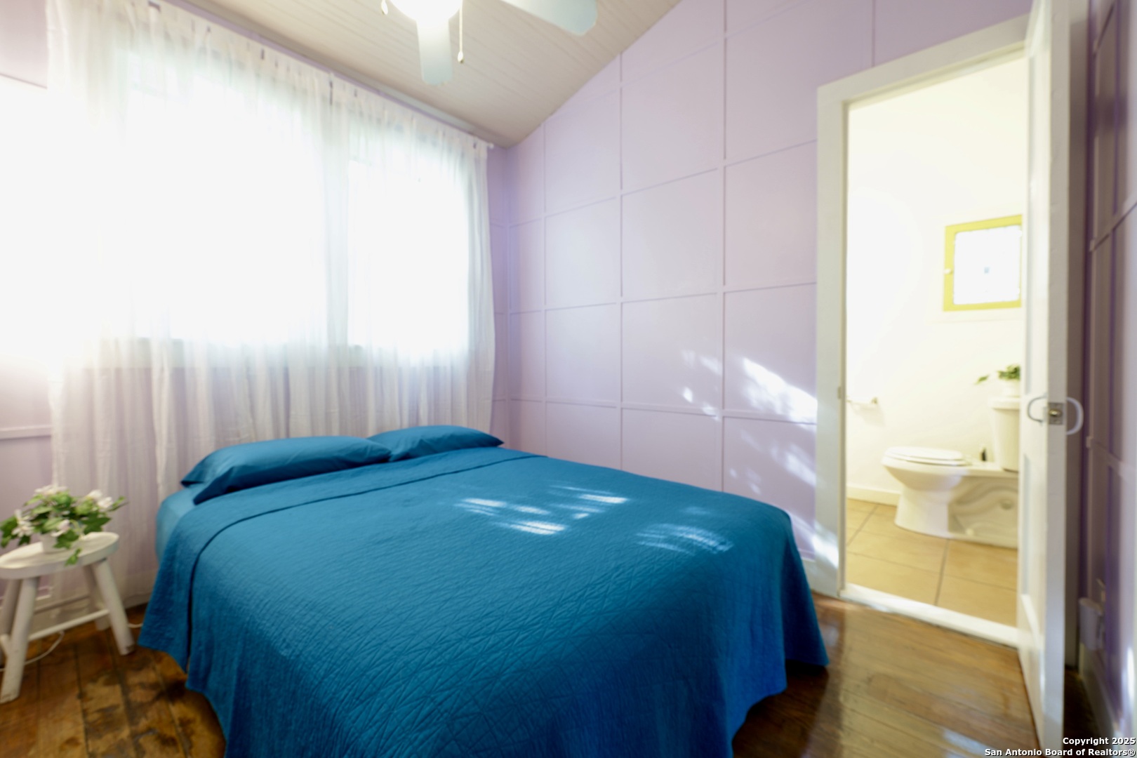 410 Riddle Street San Antonio, TX 78210 - Photo 15 of 22 a bedroom with a bed and a potted plant