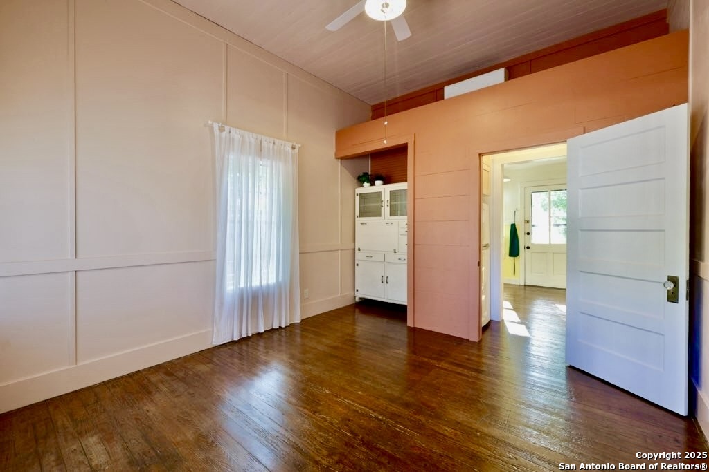410 Riddle Street San Antonio, TX 78210 - Photo 5 of 22 an empty room with wooden floor and windows