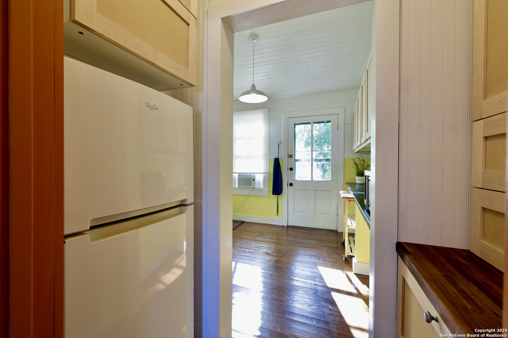 410 Riddle Street San Antonio, TX 78210 - Photo 7 of 22 a view of a hallway with wooden floor table and chairs