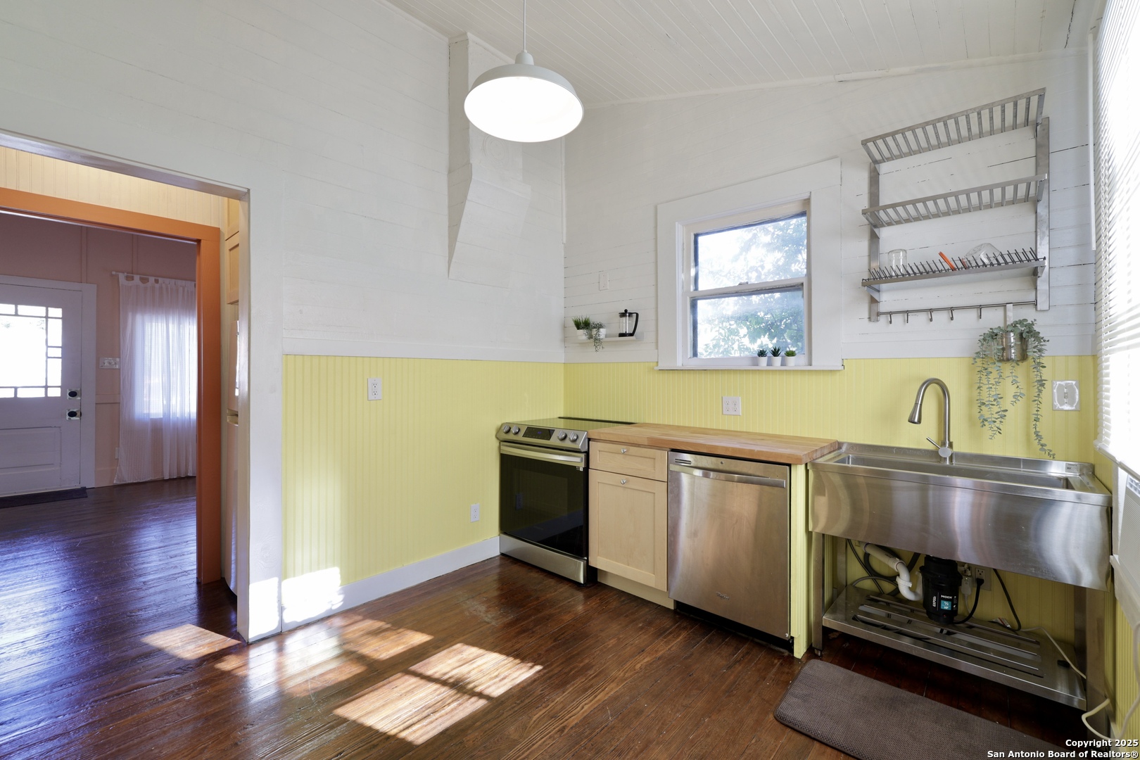 410 Riddle Street San Antonio, TX 78210 - Photo 9 of 22 a kitchen with stainless steel appliances granite countertop a sink and a wooden floor