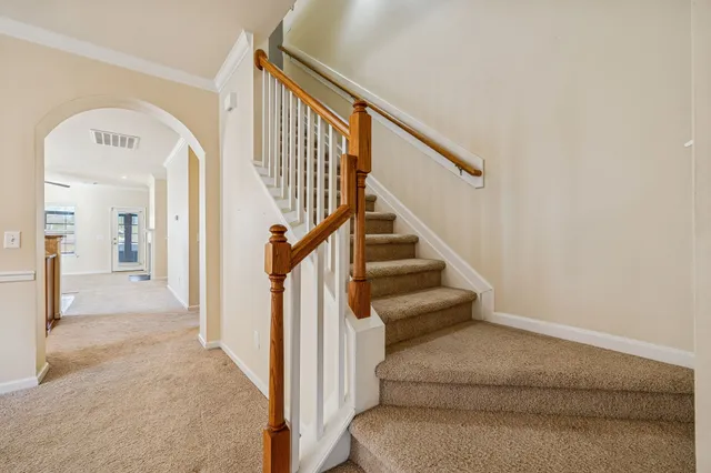 a view of entryway and hall with wooden floor