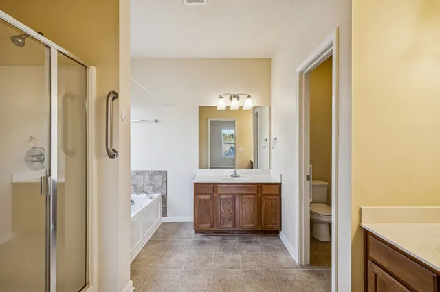 an empty room with chandelier fan